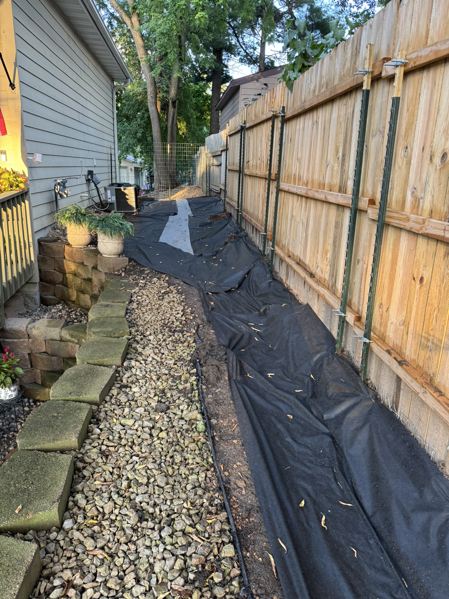 Landscape fabric laid the length of a side yard drainage run in Mound Minnesota
