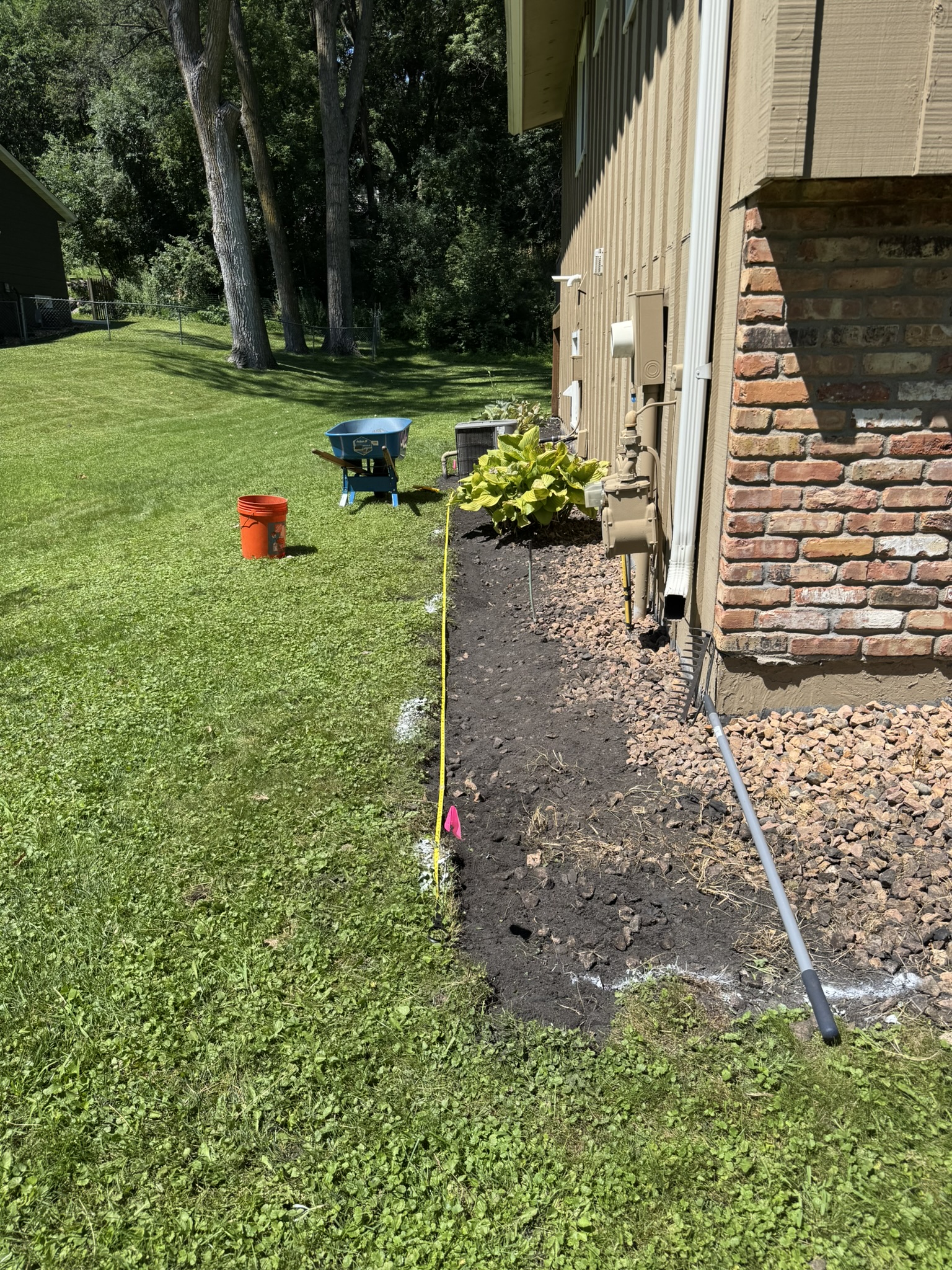 Front bed dug out around marked gas and electrical lines in Minnetonka Minnesota