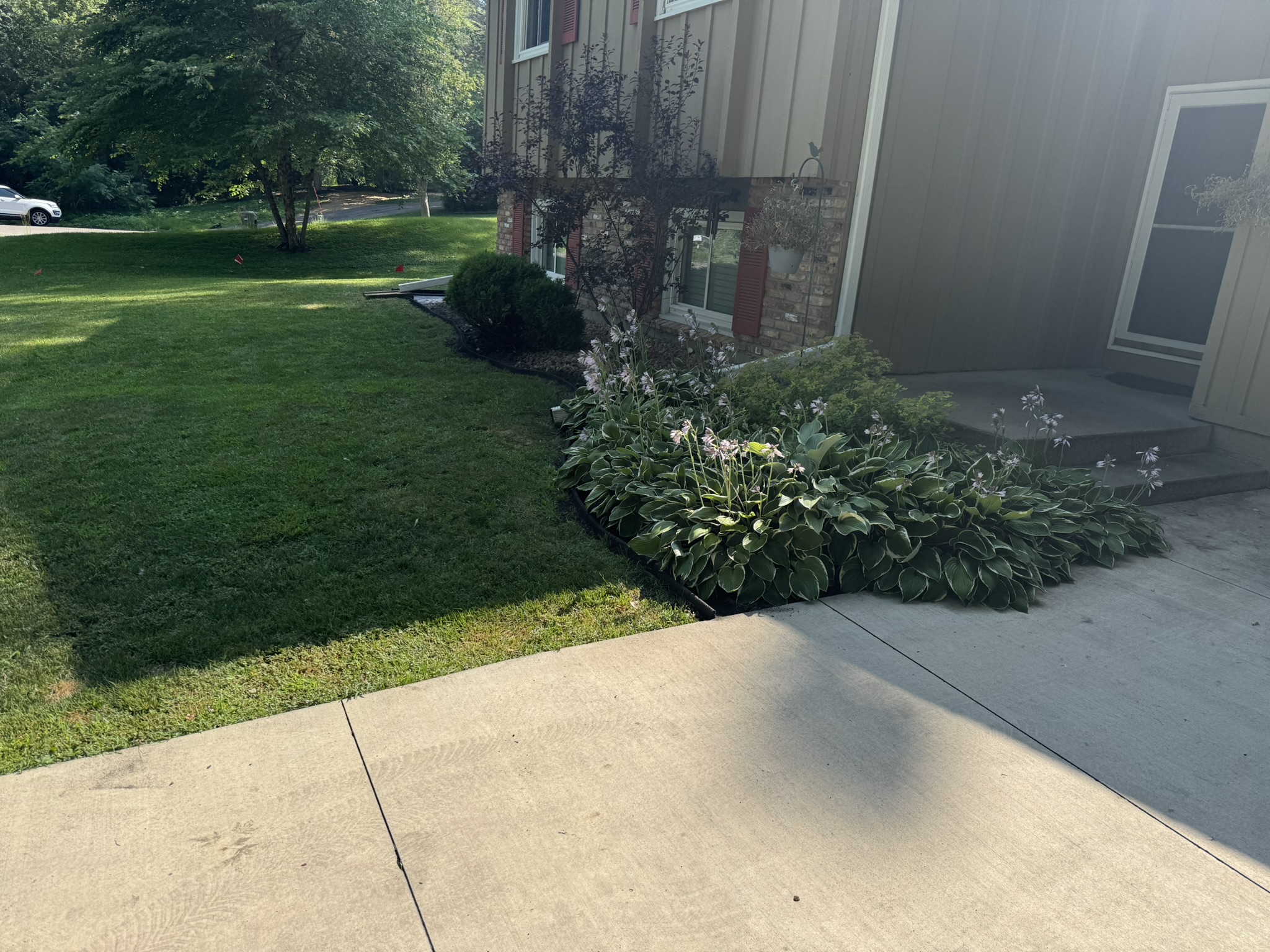 New front bed edging brought flush with the driveway in Minnetonka Minnesota