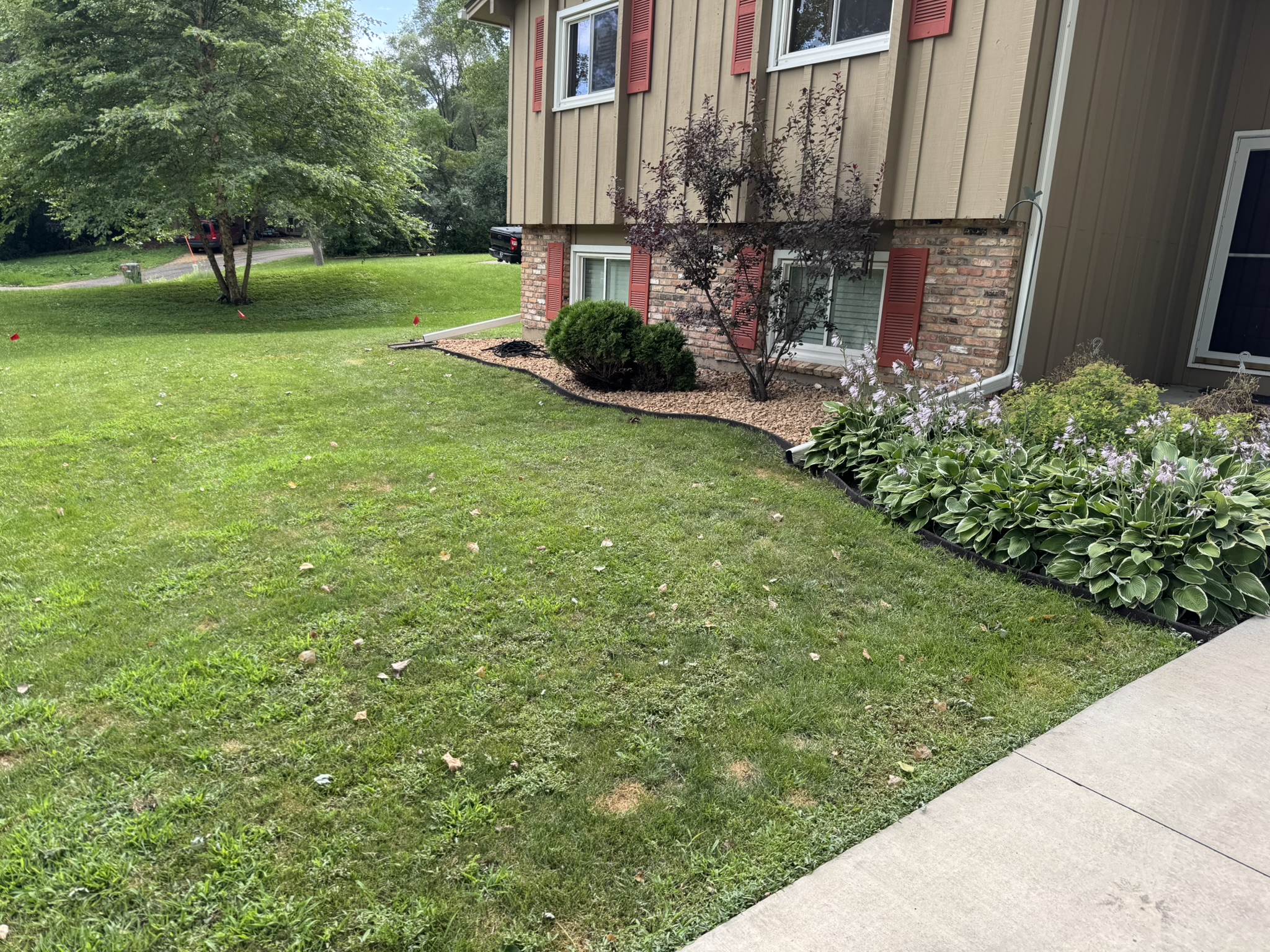 Decorative rock being laid into the finished front bed in Minnetonka Minnesota